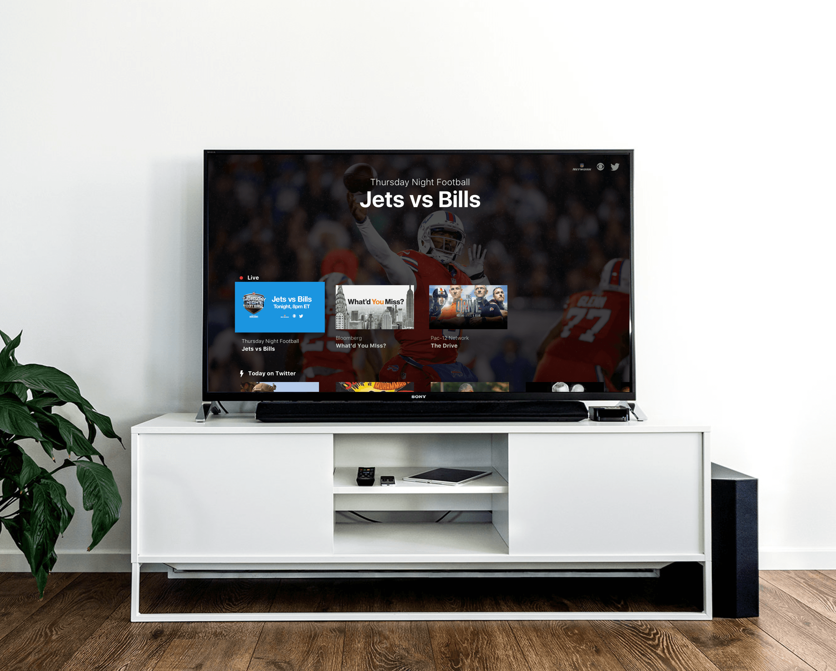 Large TV on TV stand showing the Twitter  (X) TV app