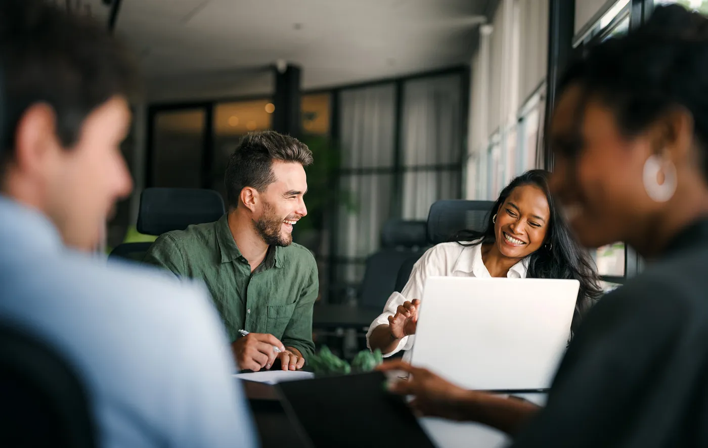 four people working together in an office